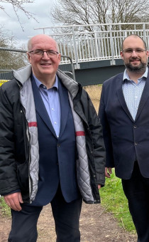 Councillors Morris and Rouse stand alongside the King George Playing Fields footbridge